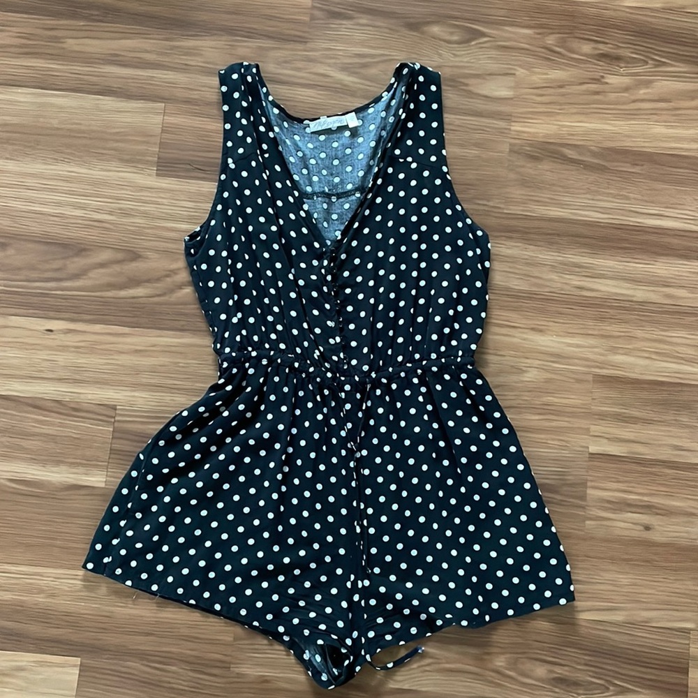 Black and white polka dot romper in good condition, size M.